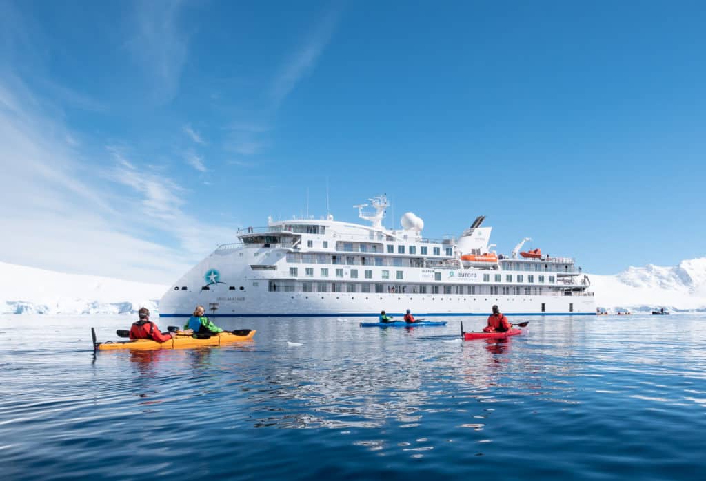 Kayakers next to Greg Mortimer